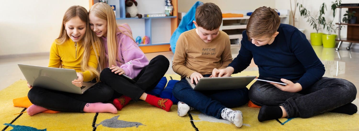 Children with laptops and tablets — English opens the door to a world of stories and games